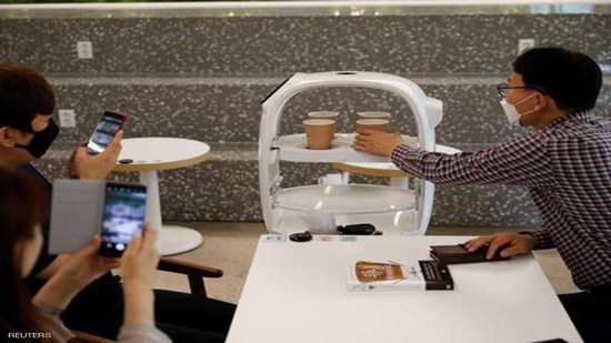 صور لروبوت يساهم في تطبيق التباعد الاجتماعي بالمقاهي